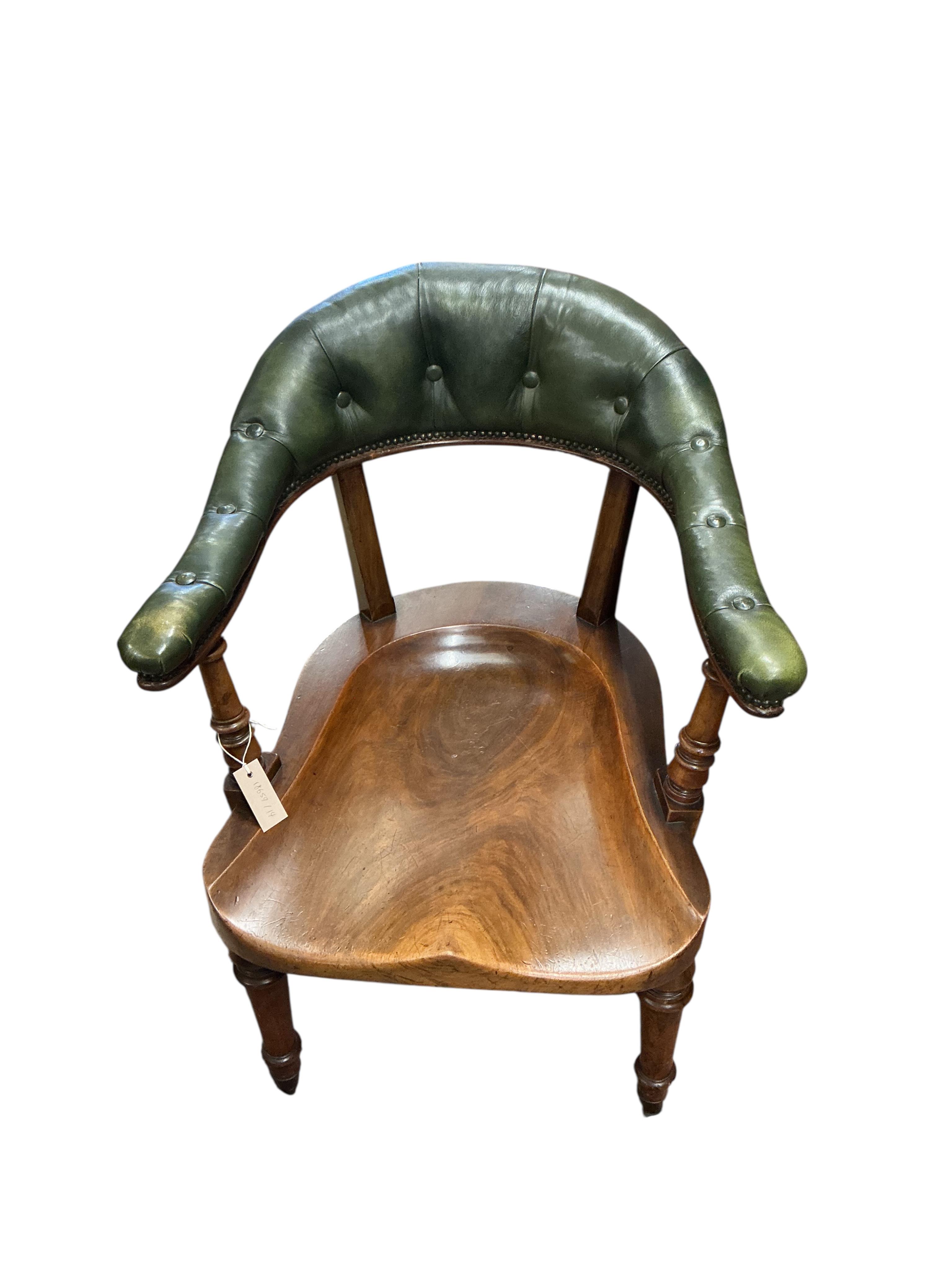 A Victorian mahogany and green buttoned leather desk chair, width 62cm, depth 60cm, height 85cm